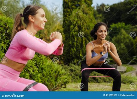 Two Athletic Women Doing Squats with Resistance Bands in Park Stock Image - Image of healthcare ...