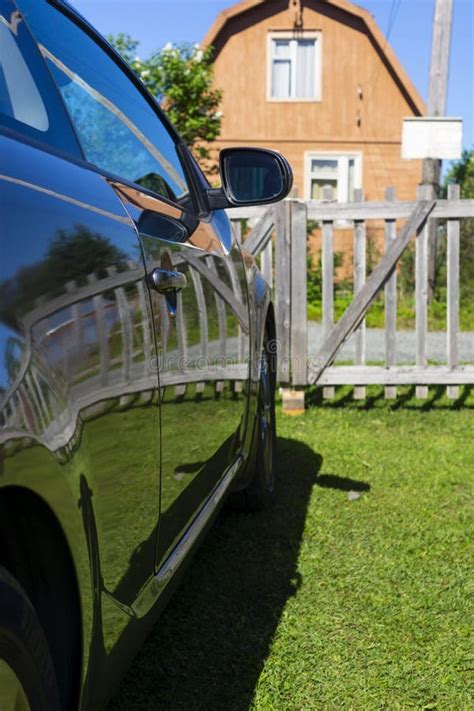 Car On Lawn Behind The Fence At Home On A Summer Day Stock Image