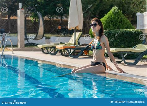 Young Beautiful Woman Relax And Chill In Luxury Swimming Pool Stock