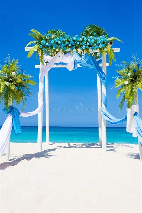 Wedding Arch Decorated With Flowers On Tropical Sand Beach Outdoor