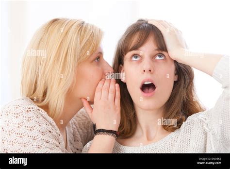 View Of Blonde Girl Telling A Secret To Her Best Friend Stock Photo Alamy