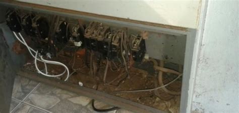 An Electrical Panel With Multiple Wires And Plugs On It In A Room That