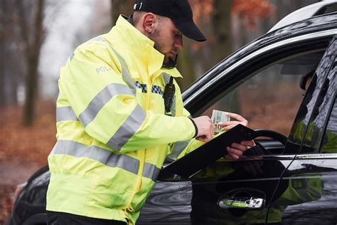 Premium Photo Male Police Officer In Green Uniform Taking Bribe From