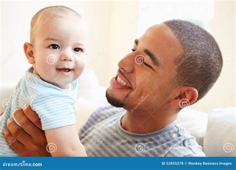 Smiling Father Playing With Baby Son At Home Stock Photo Image Of