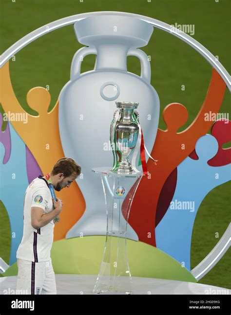 England's Harry Kane walks past the trophy after receiving his runner ...