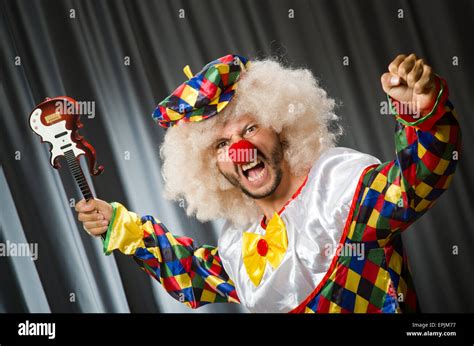 Angry clown with guitar in funny concept Stock Photo - Alamy