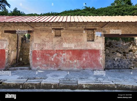 Roman political campaign graffiti on a wall in a Pompeii street, Italy ...