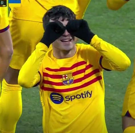 A Soccer Player Is Covering His Eyes While Standing In Front Of The