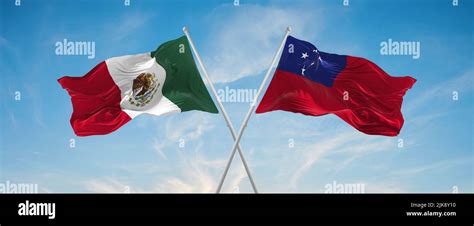 Two Crossed Flags Samoa And Mexico Waving In Wind At Cloudy Sky