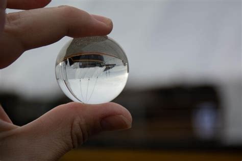 Premium Photo Close Up Of Person Holding Crystal Ball With Boat