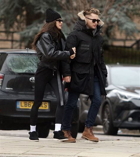 AJ Pritchard Wraps Up In A Black Coat As He Holds Hands With Girlfriend