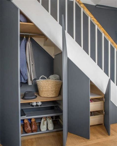 An Open Closet Under The Stairs In A House