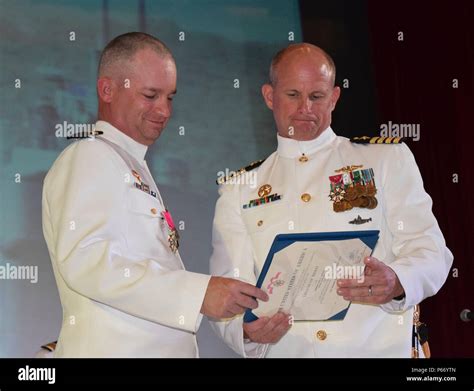 Capt Jeffrey Grimes Right Presents Cmdr Lance Thompson With The