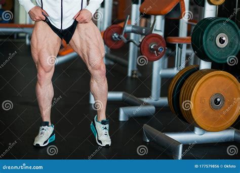 Male Muscular Athlete Bodybuilder Show Thigh Muscles Stock Photo