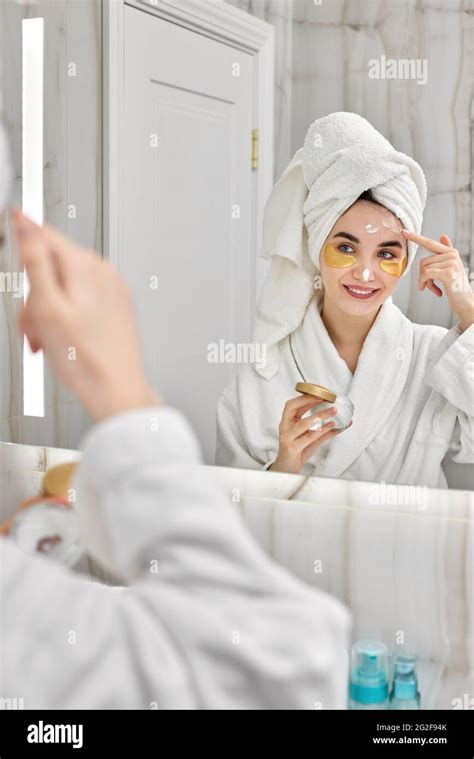 Beautiful Woman With Eye Patches In White Bathrobes In Bathroom Stock