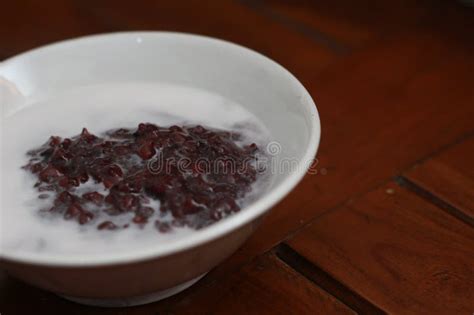 A Bowl of Black Sticky Rice Porridge with Coconut Milk Stock Image ...