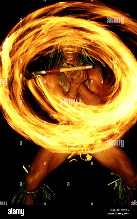 Spectacular Polynesian fire dancer entertains tourists at a luau on the ...