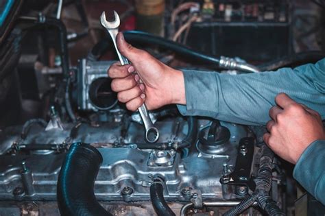 Premium Photo Cropped Hands Of Mechanic Holding Wrench