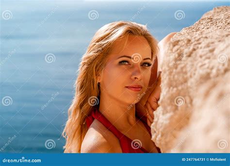 Smiling Young Woman In A Red Dress Looks At The Camera A Beautiful