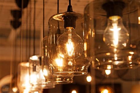 Premium Photo Lamps Hanging From The Ceiling In A Row Of Naked Light Bulbs