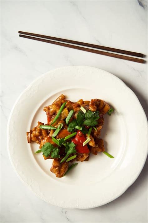 Chicken Manchurian On White Plate With Chopsticks White Marble