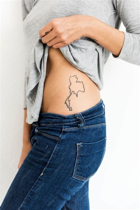 Premium Photo | Woman is showing thailand map tattoo on her waist