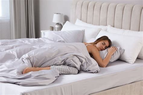 Beautiful Woman Sleeping In Comfortable Bed With Silky Linens Stock