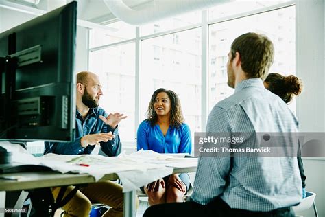 Businessman Leading Discussion During Meeting High Res Stock Photo