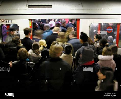 Rush Hour Commuters Packing On To Rush Hour Trains During Morning On