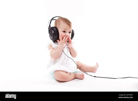 baby with headphones on white background Stock Photo - Alamy