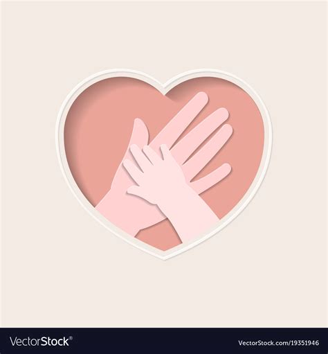 Hands of mother and baby in heart shaped paper art