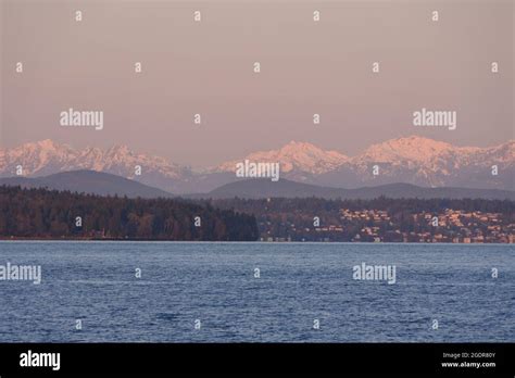 A Winter's sunrise bathes the Olympic Mountains in light Stock Photo ...