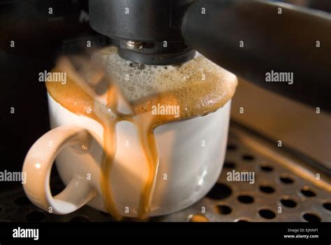 Coffee Cup Overflowing In A Coffee Machine Stock Photo Alamy