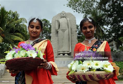 sri lankan girls attired  traditional dance costume await