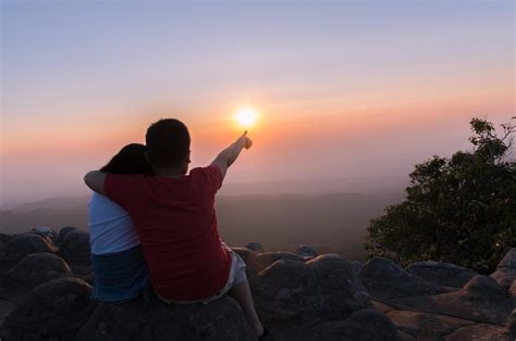 brother and sister sitting on rock and see sunset together 21918605 ...