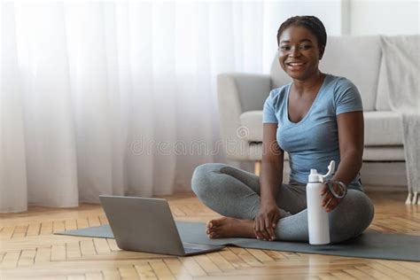 Worried Black Lady Looking At Smartphone Screen Sitting On Couch At