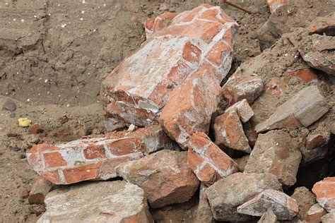 Pile Of Broken Red Bricks On Construction Site Photo Background And