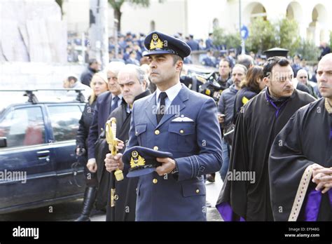 A Hellenic Air Force officers carries the cap and sword of the killed ...