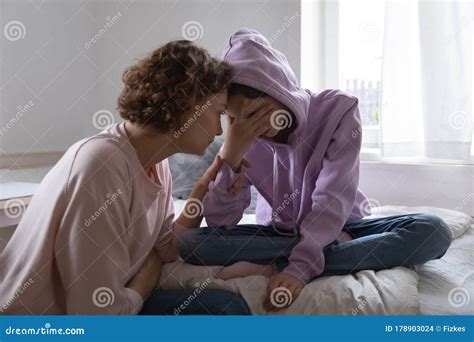 Worried Mom Comforting Depressed Teen Daughter Crying At Home Stock