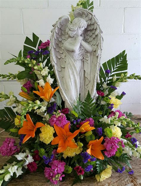 Angel Arrangement With Orange Lillies White Snaps Yellow Carns