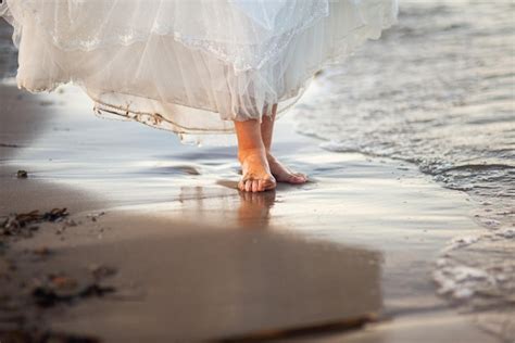 Premium Photo Girls Feet Walking Along The Seashore