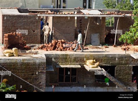 Builders On An Indian Construction Site Building A New House Stock