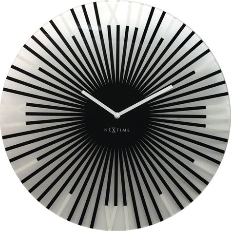 A Black And White Clock With Roman Numerals