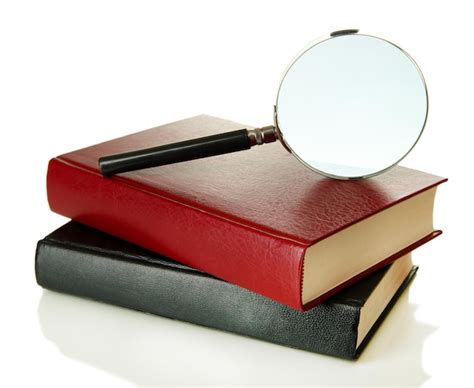 Premium Photo | Magnifying glass and books isolated on white