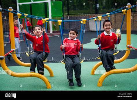 Happy smiling children playing in the playground of Primary school in ...