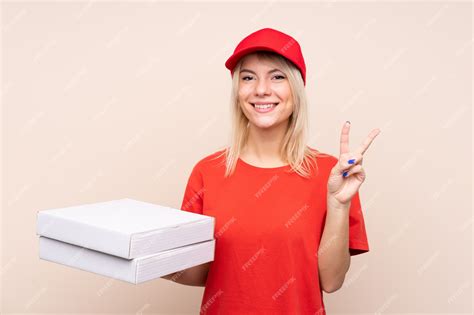 Premium Photo Pizza Delivery Russian Woman Holding A Pizza Over Isolated Wall Smiling And