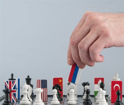 Premium Photo Politicians Hand Moves A Chess Piece With A Flag