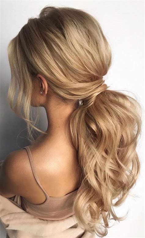 A Woman With Long Blonde Hair In A Ponytail