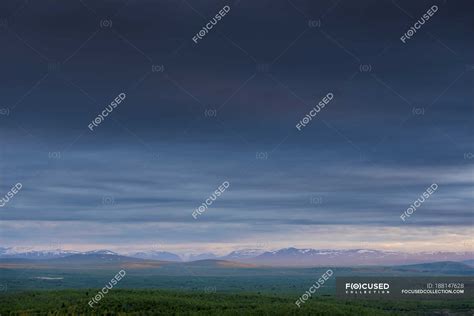 Landscape view of mountain range on horizon and moody sky — overcast, picturesque - Stock Photo ...