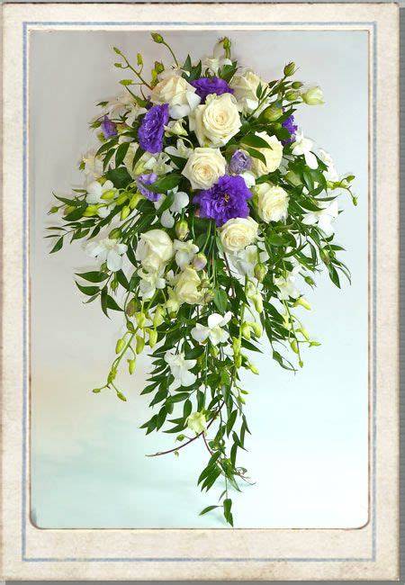 a bouquet of white and purple flowers in a frame